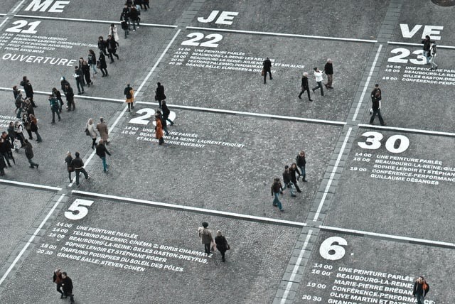 Street scene with a large calendar and people walking